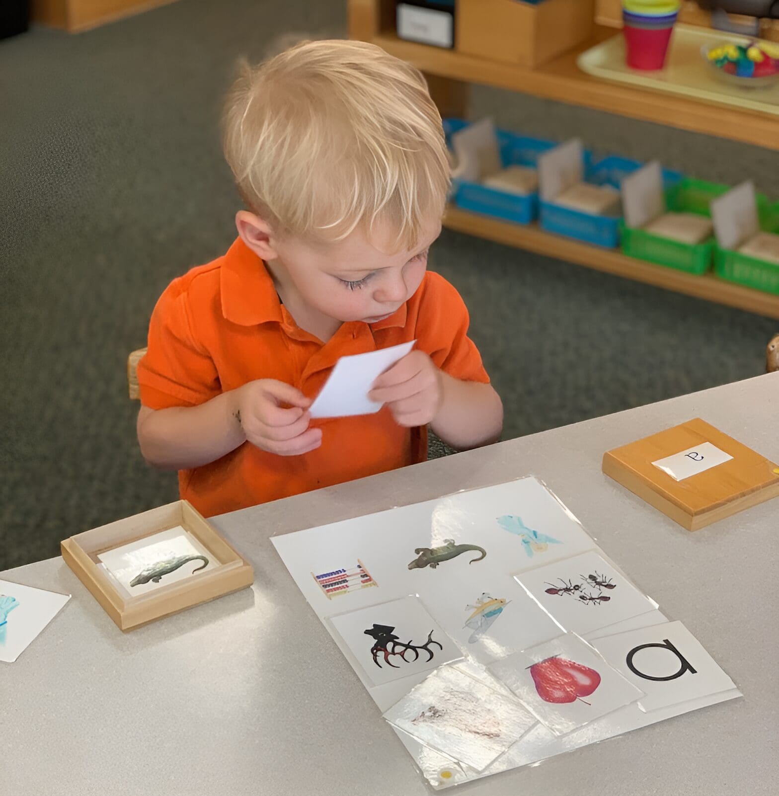 A young boy is playing with some stickers.