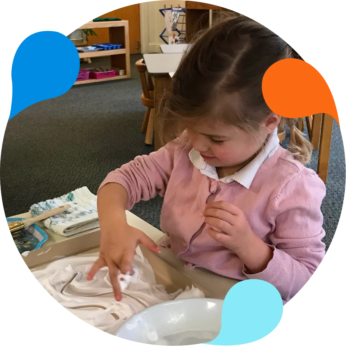 A little girl is making paper mache.